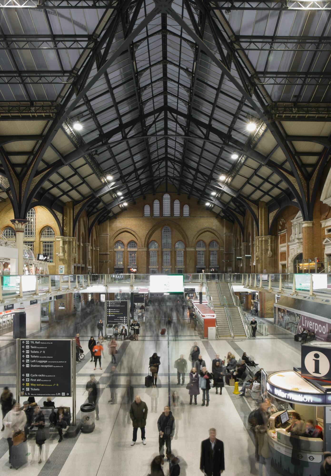 Interior of Liverpool Street Station with a busy concourse and high vaulted ceiling