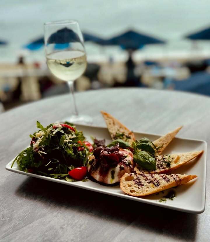 Seafood dish with wine at The Deck on Laguna Beach