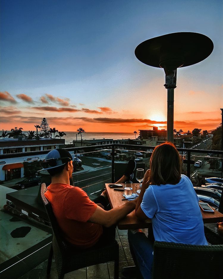 Couple enjoying sunset views at Mozambique rooftop lounge