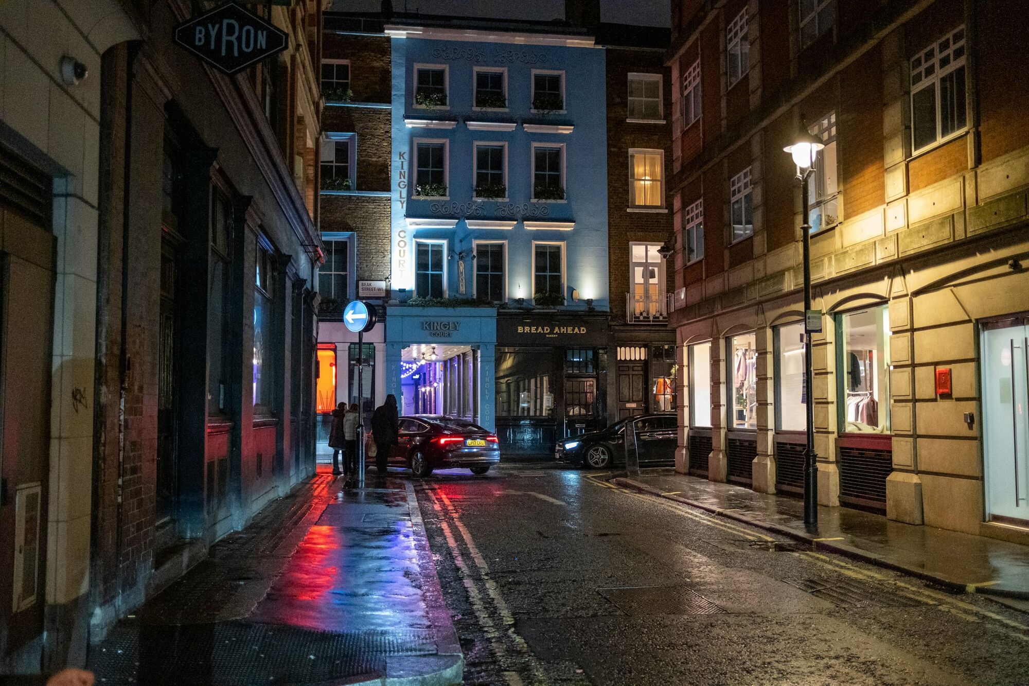 Quiet London street at night with wet pavement