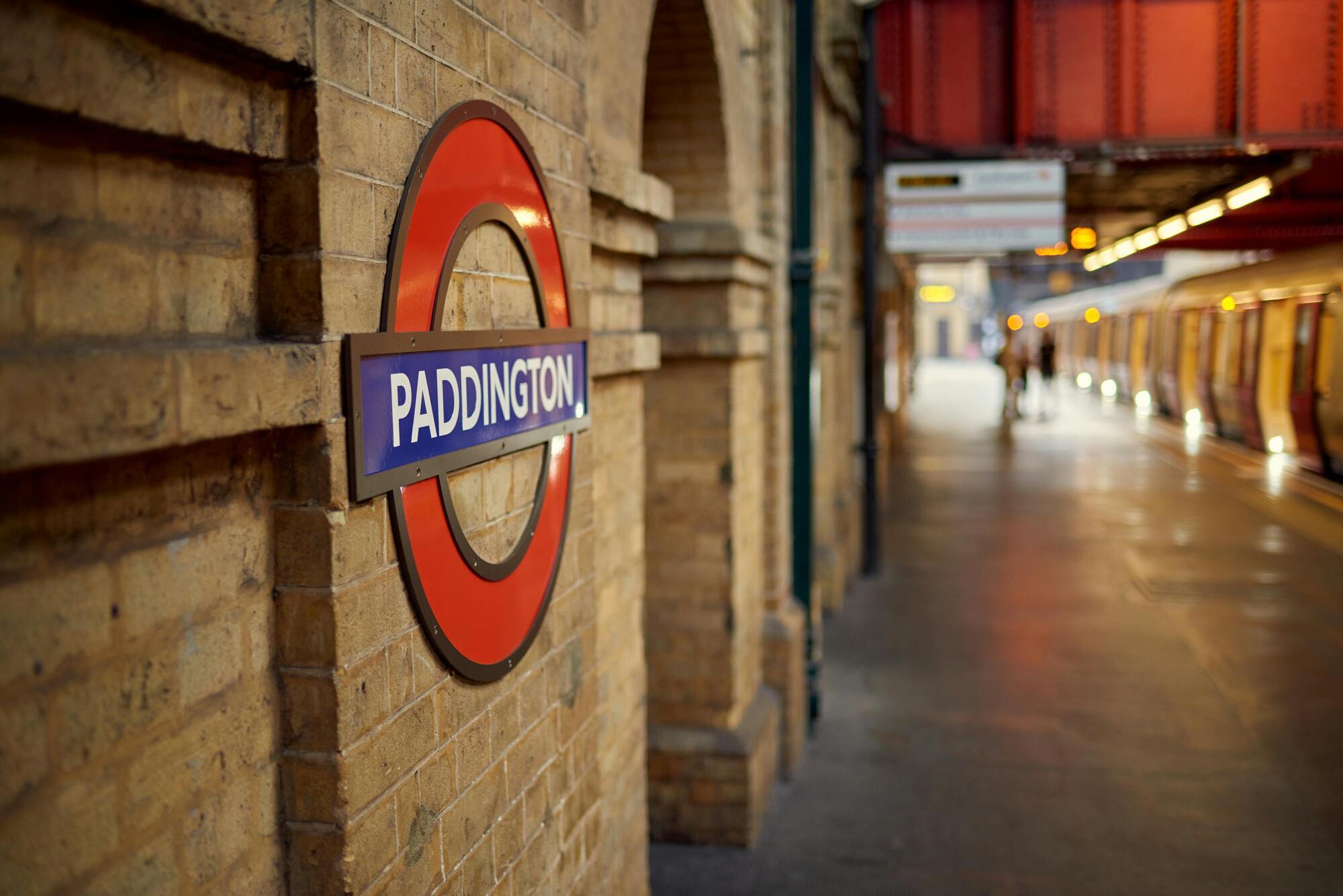 Paddington Station sign on a wall in London Underground