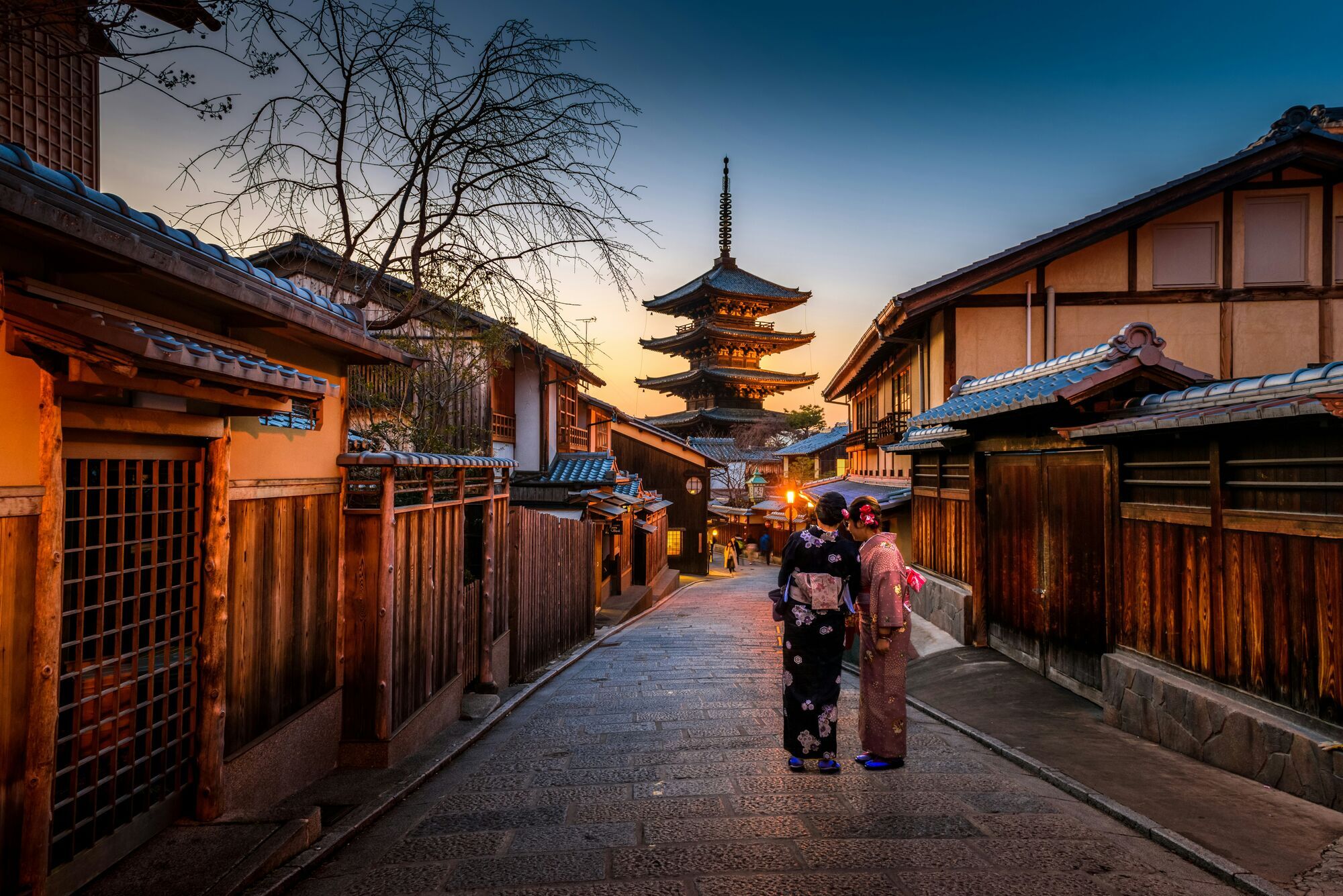 two-women-in-purple-and-pink-kimono-standing-on-street