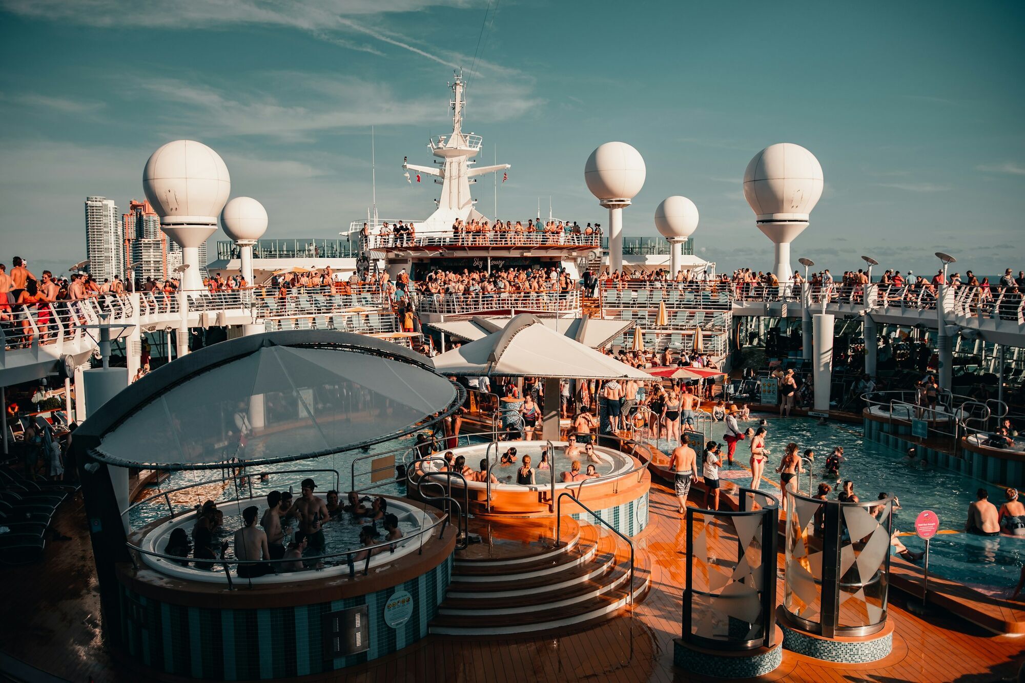 Passengers enjoying pool and deck area on a cruise ship