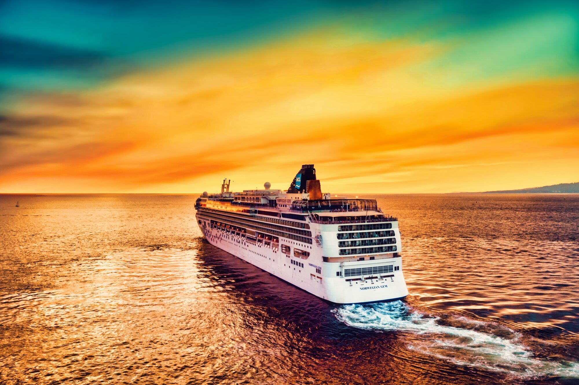 Cruise ship sailing at sunset