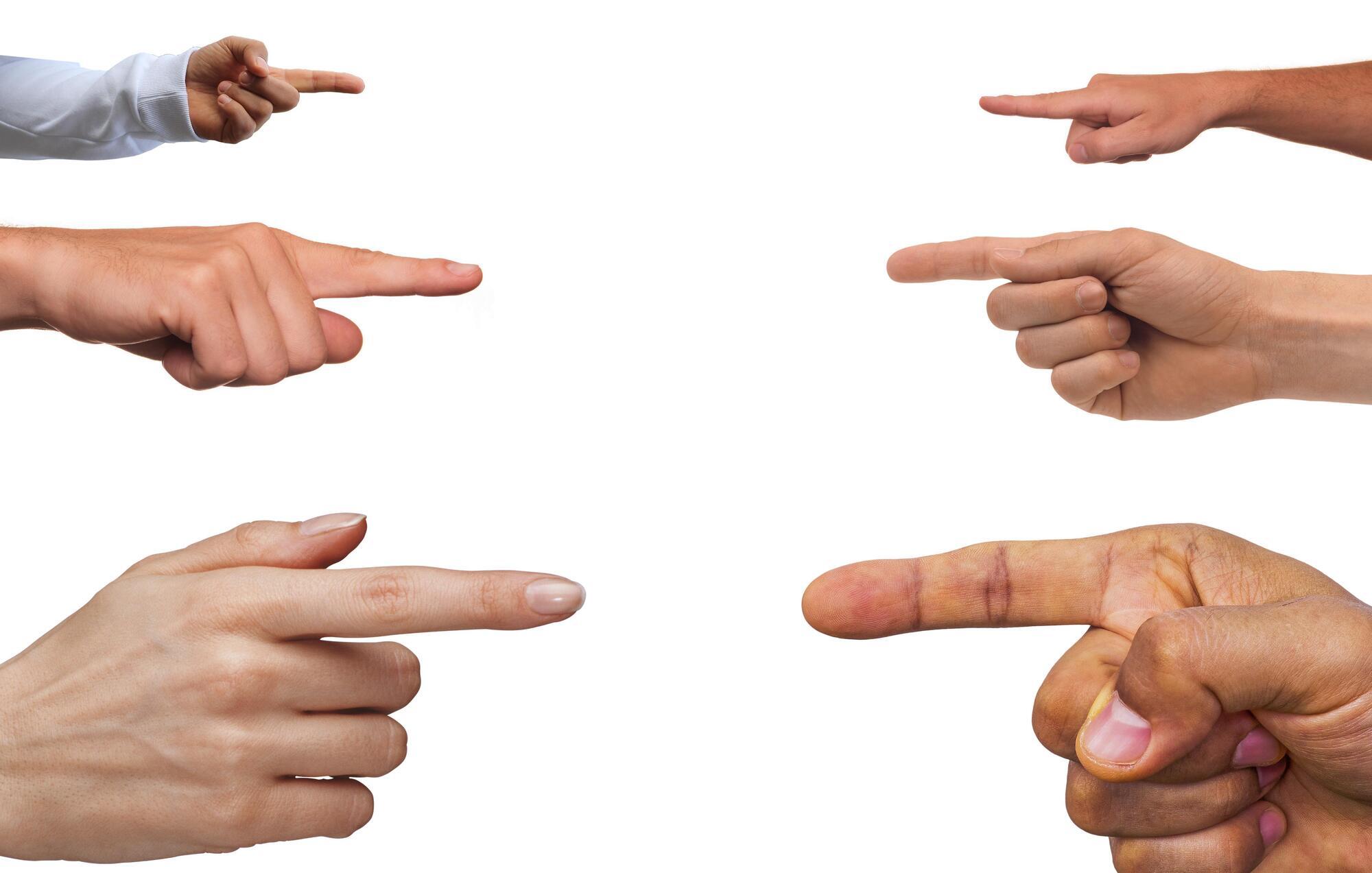 Multiple hands pointing in different directions, representing blame or accusation