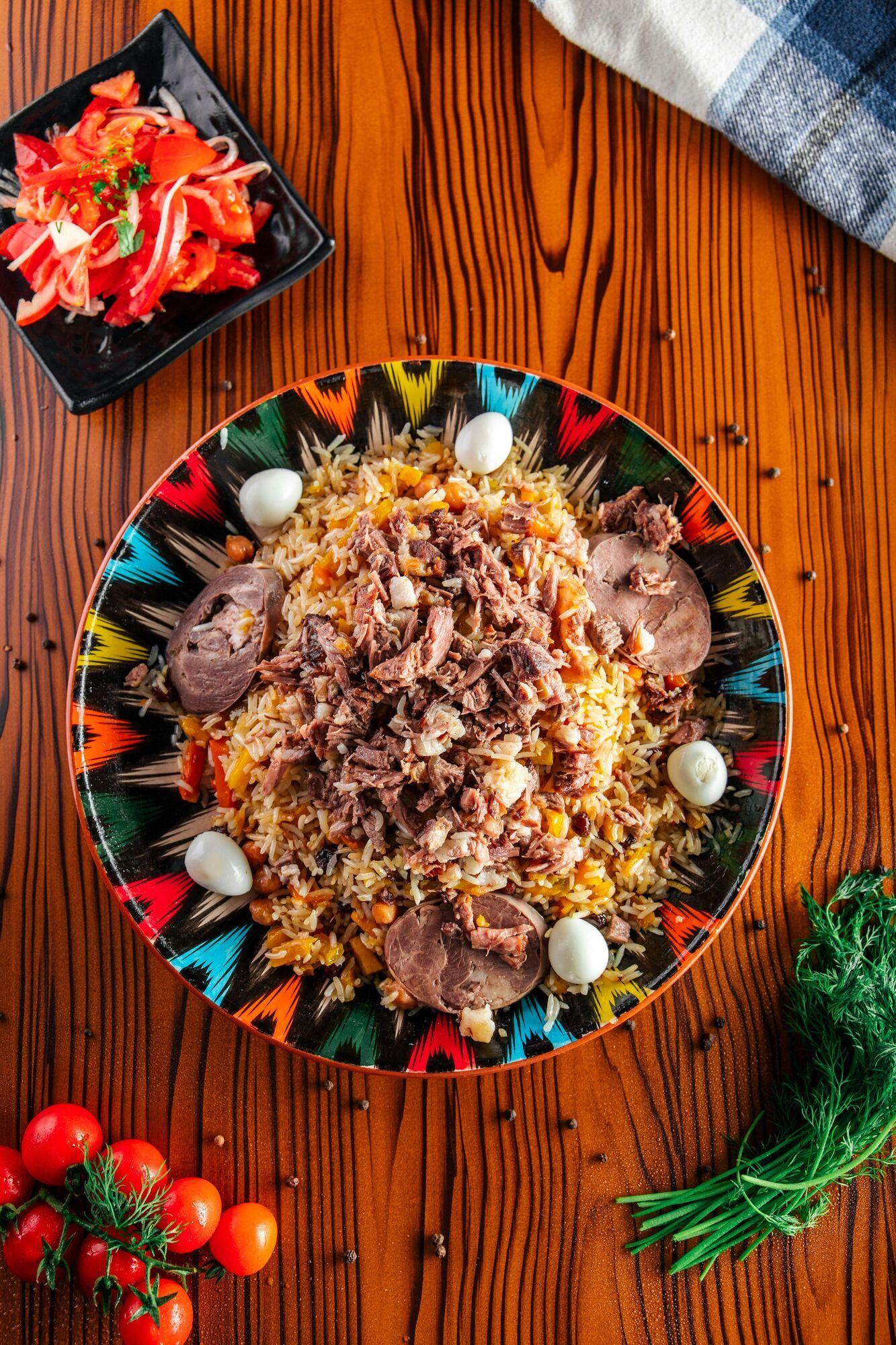 a plate of plov on a wooden table