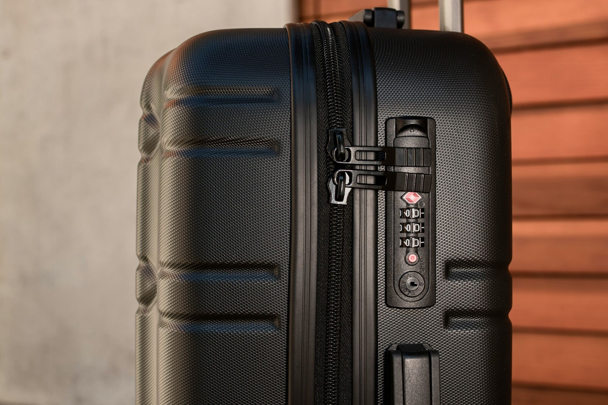 Close-up of a hard-shell suitcase with a built-in TSA-approved lock