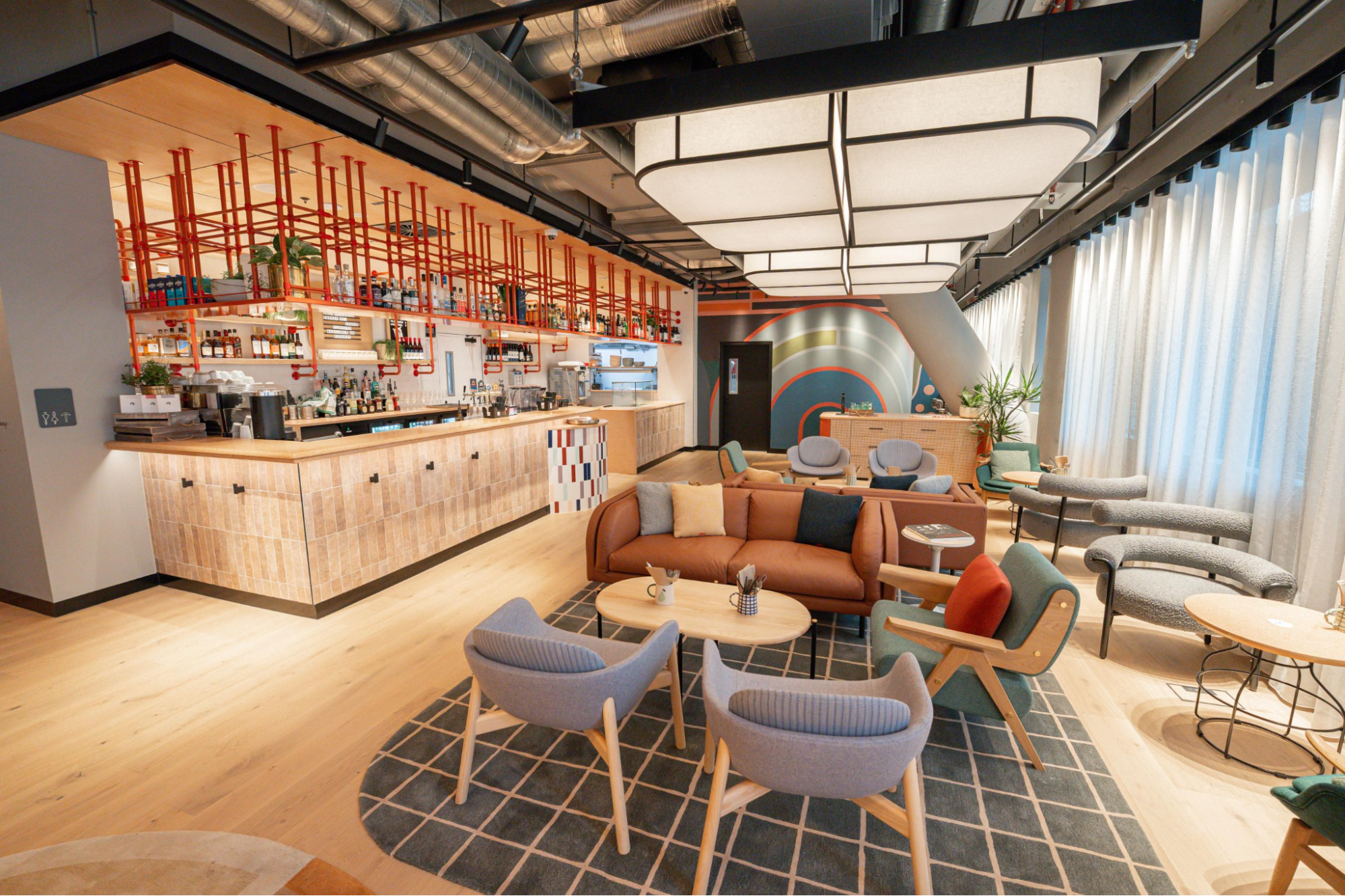 Interior of Caption by Hyatt Central Sydney’s social hub, Talk Shop, with seating and bar areas