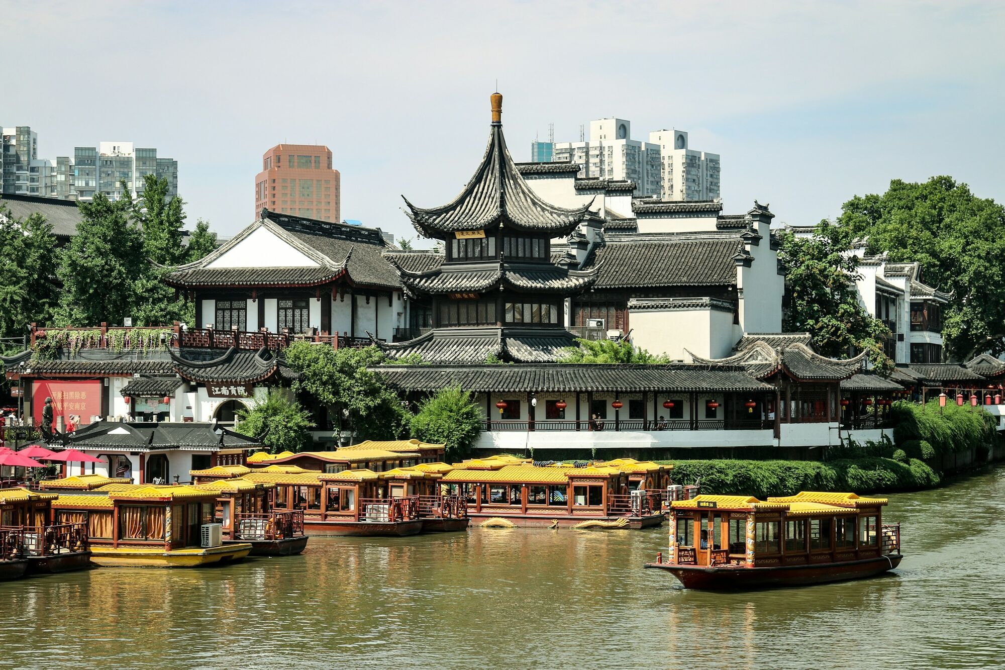 Traditional buildings and boats along the Qinhuai River in Nanjing