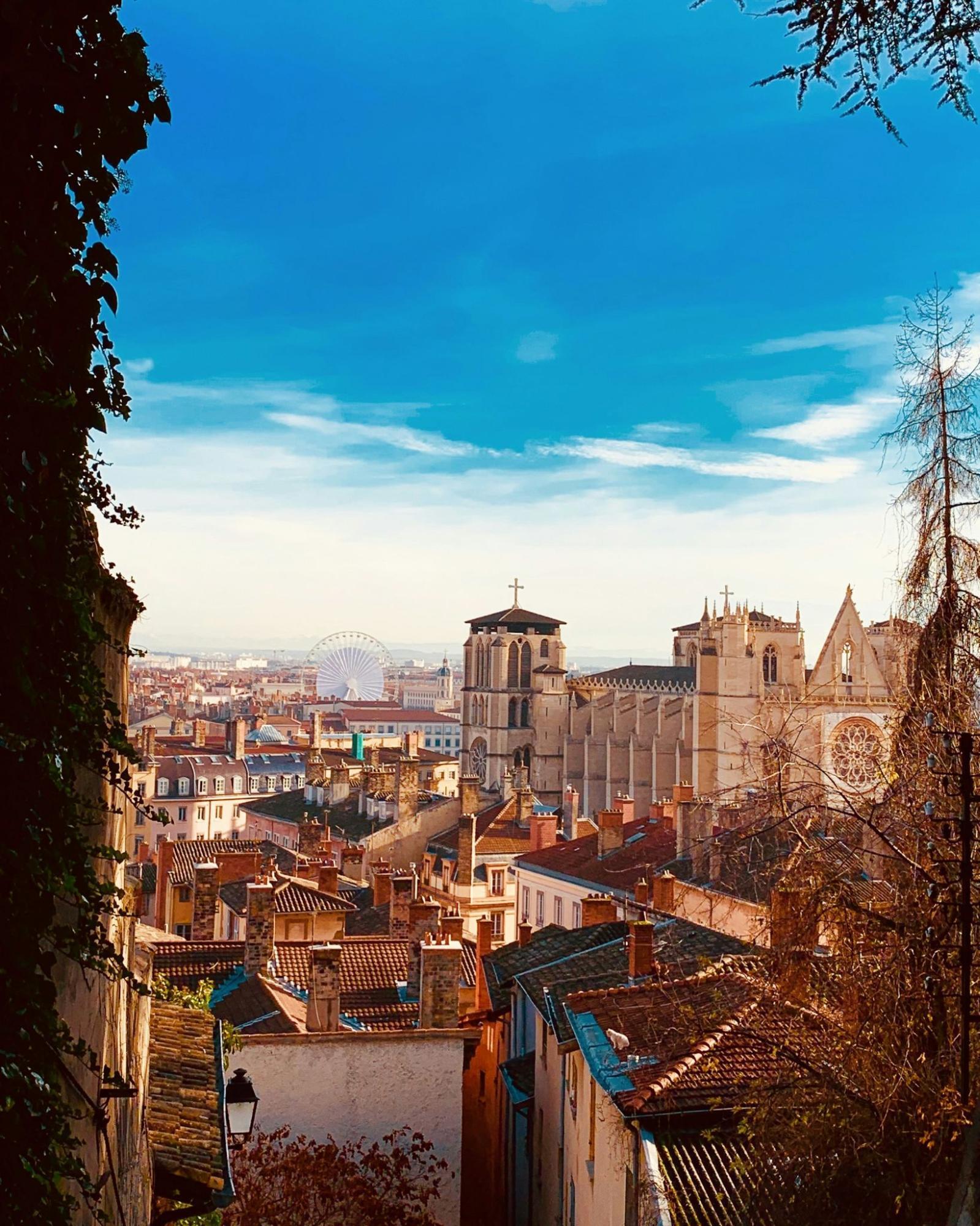 Scenic view of Lyon’s old town rooftops and cathedral under a clear autumn sky