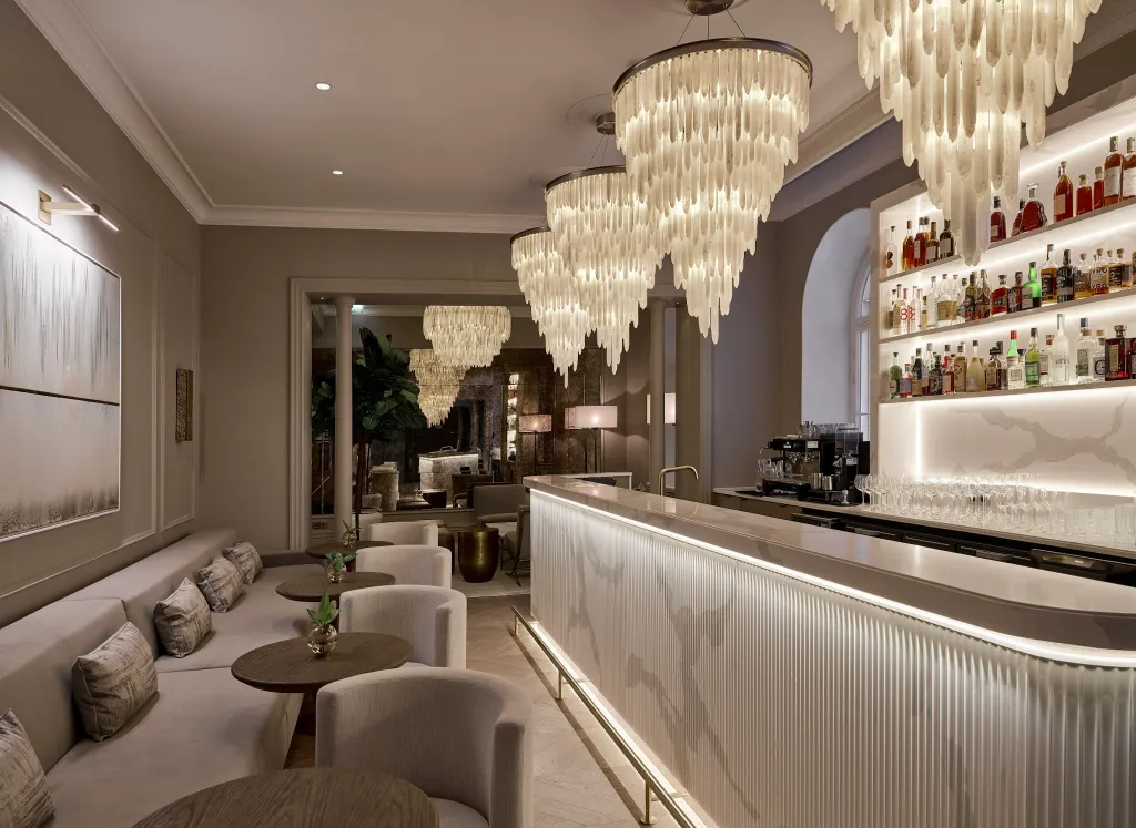 Elegant hotel bar with chandeliers and marble counter