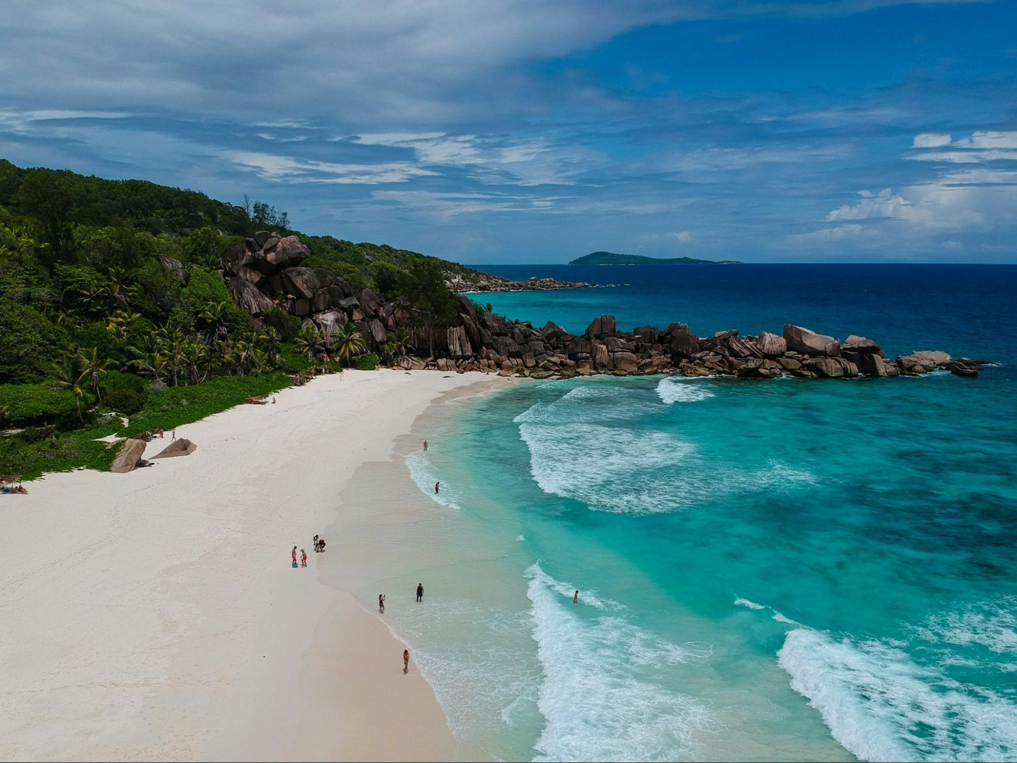 Aerial view of Anse Cocos Beach in the Seychelles with turquoise water and white sand