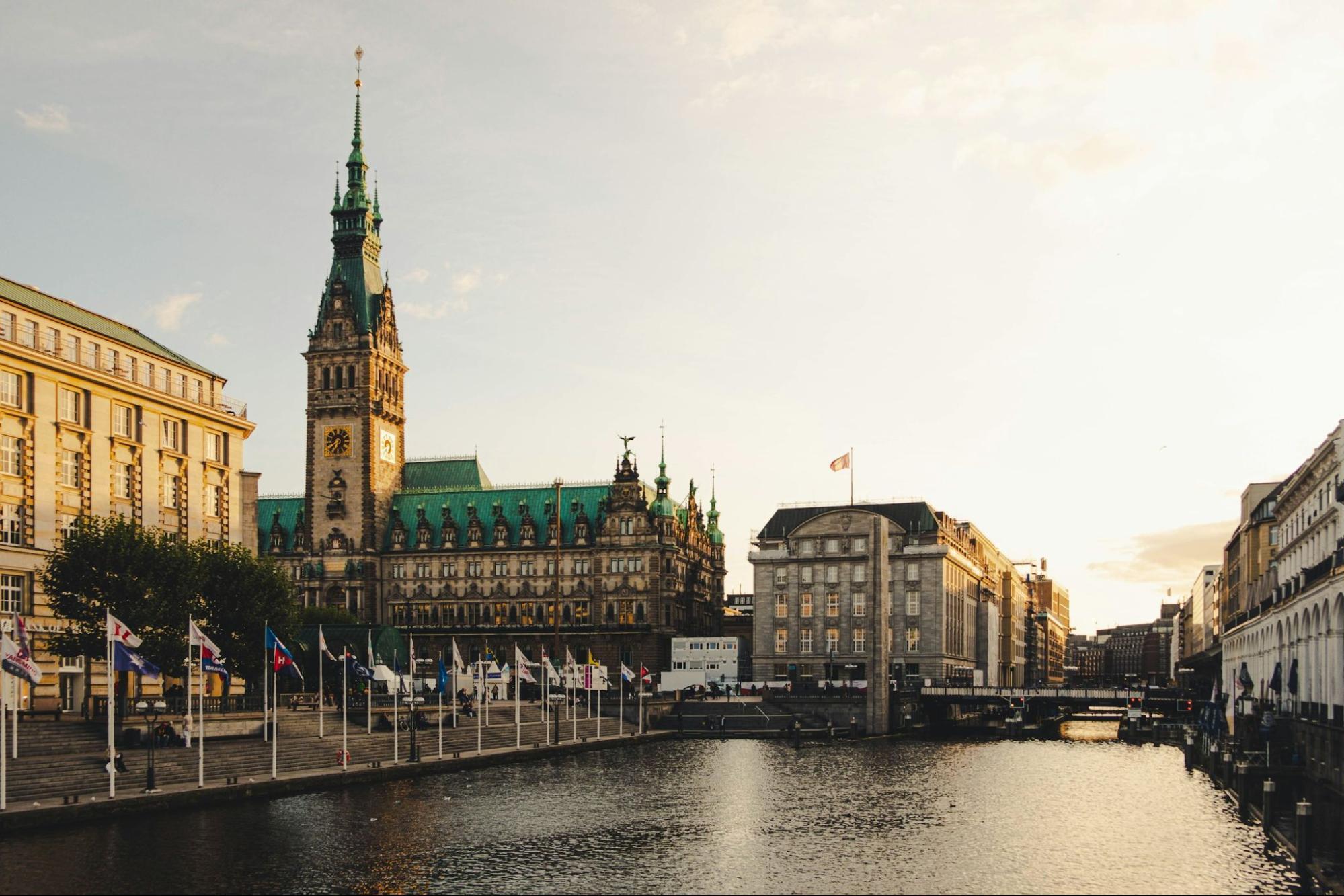 View of Hamburg City Hall and Alster Canal at sunset