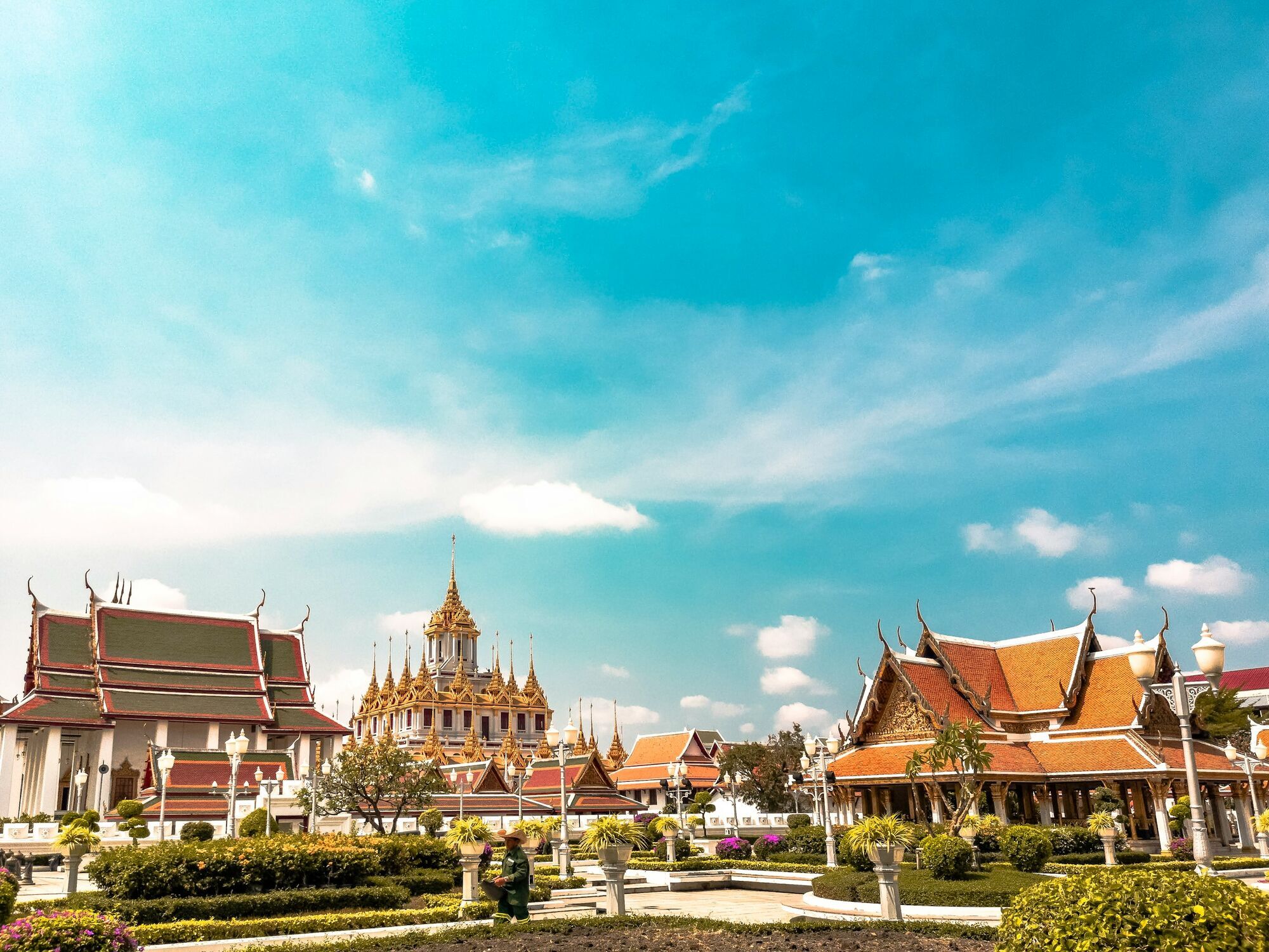 View of ornate temples in Bangkok under a clear blue sky