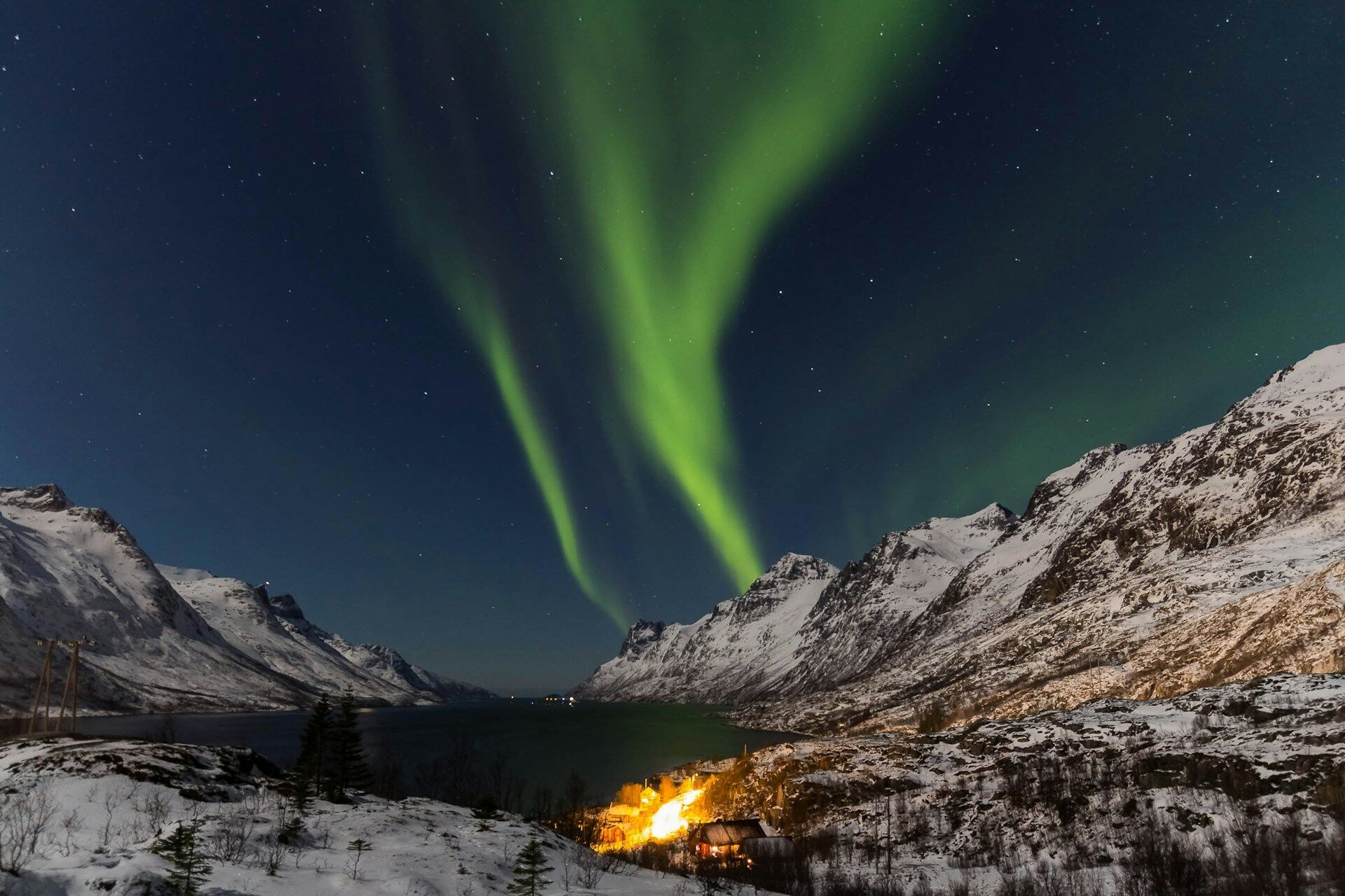 Northern Lights above snowy mountains near Tromsø, Norway