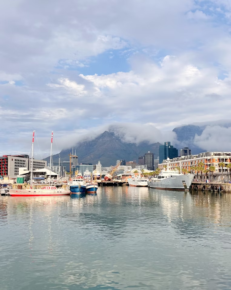 Boats docked at the Victoria & Alfred Waterfront in Cape Town with Table Mountain in the background