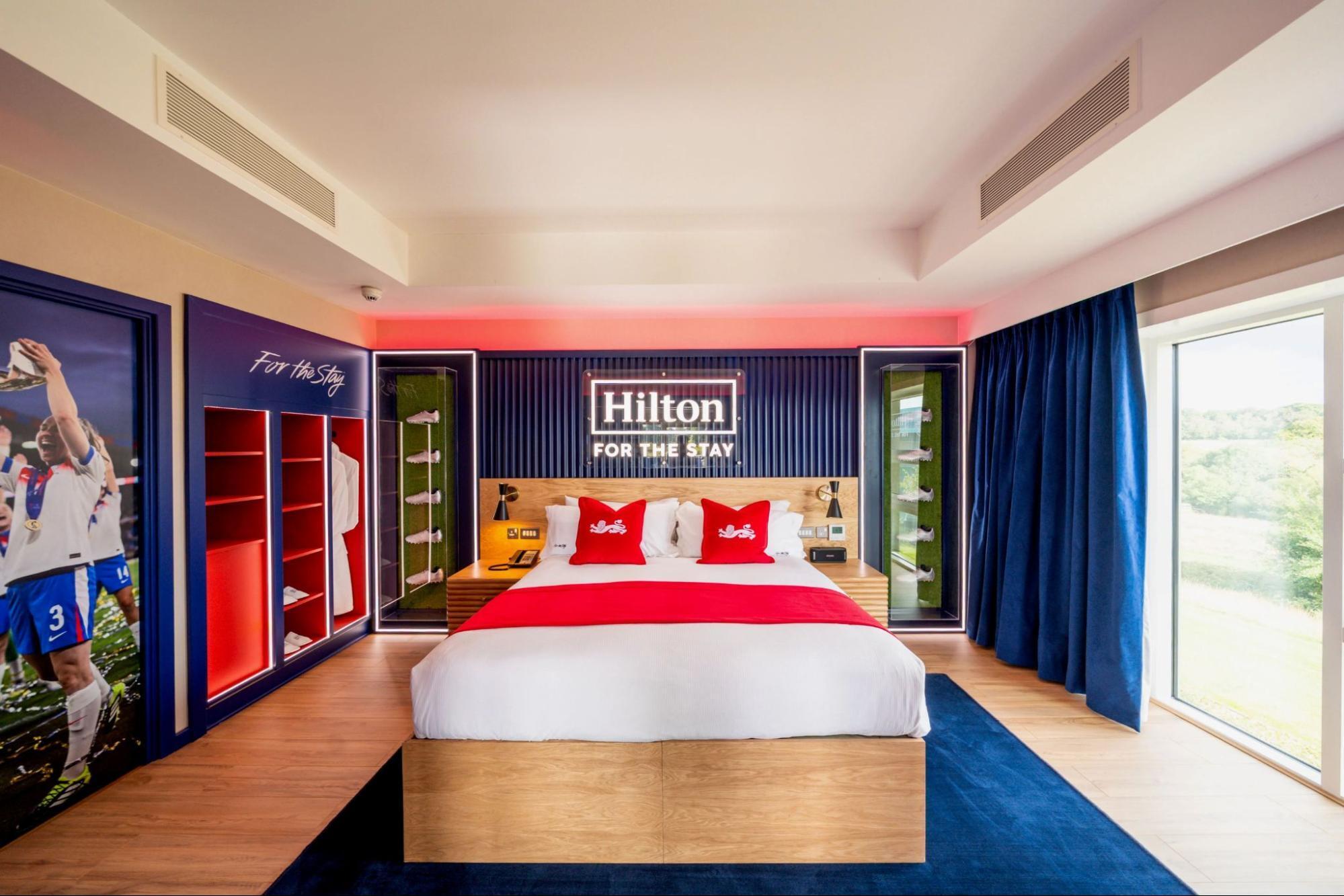 Football-themed hotel suite with memorabilia and red-and-white decor at Hilton St George’s Park