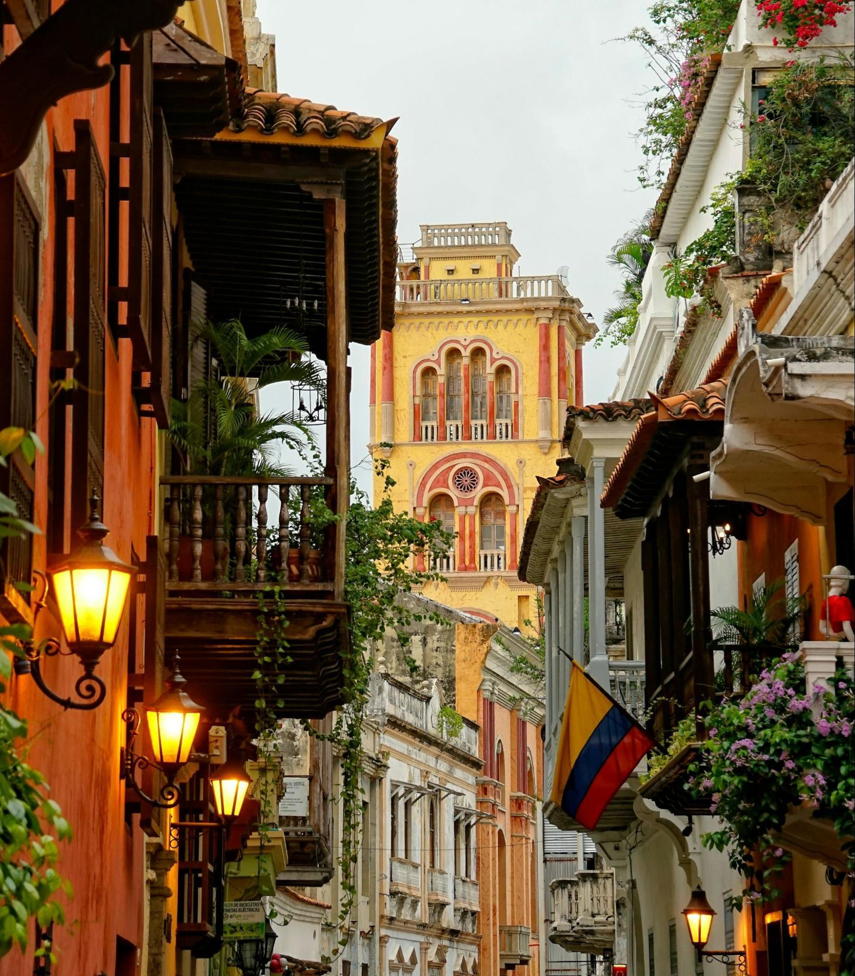 Historic street in Cartagena, Colombia with colonial architecture and the Cathedral of Cartagena in the background