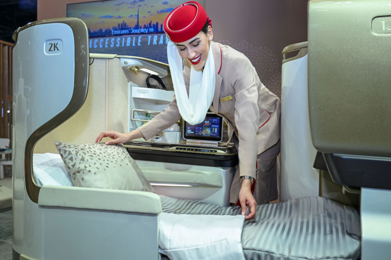 Emirates cabin crew preparing a business class seat
