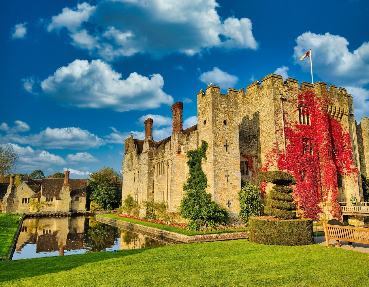 Hever Castle surrounded by autumn foliage and moat