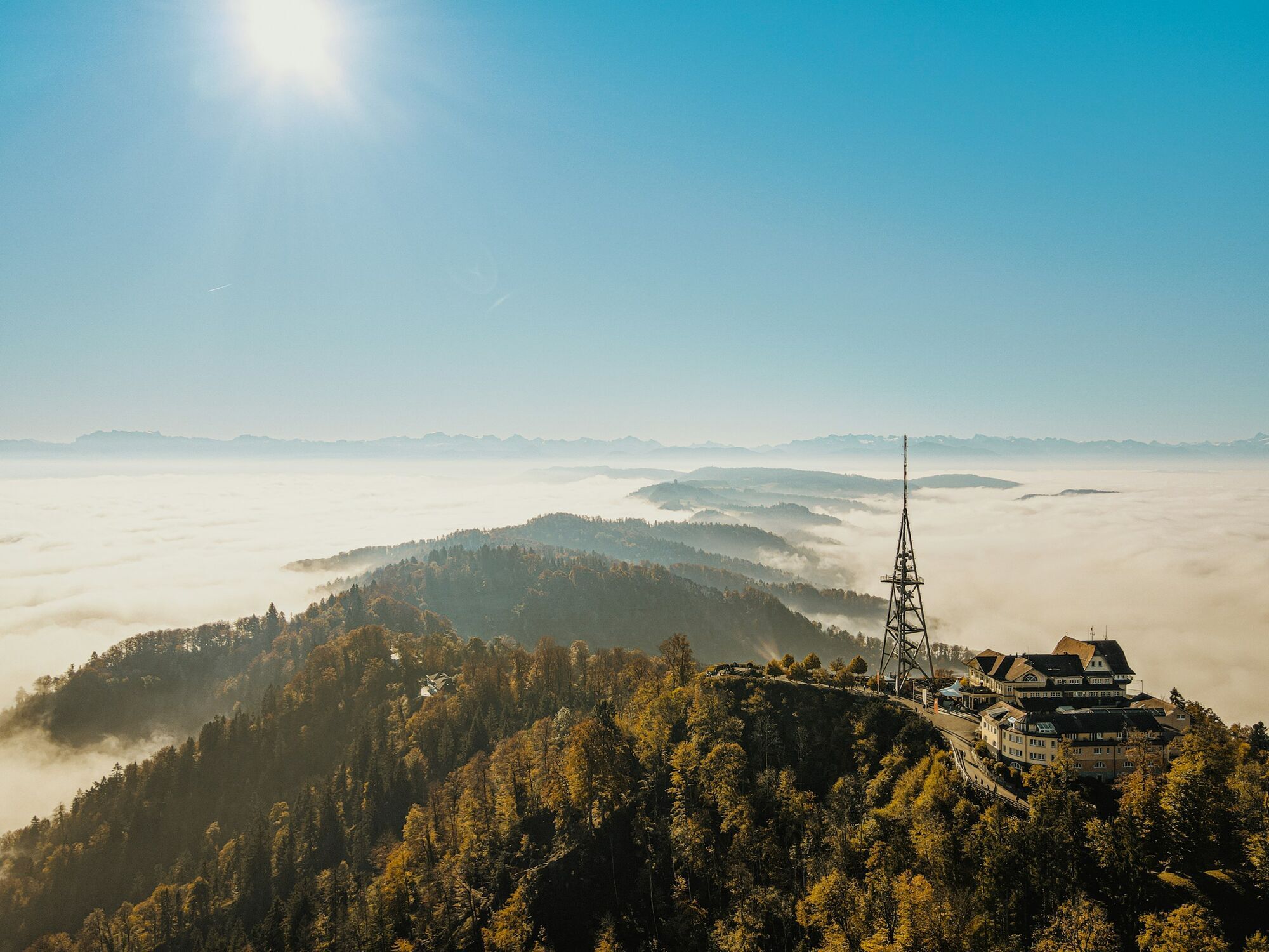 Uetliberg mountain peak above clouds with observation tower near Zürich