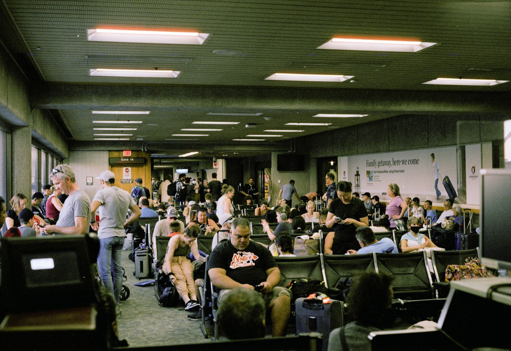 Crowded airport waiting area with delayed passengers