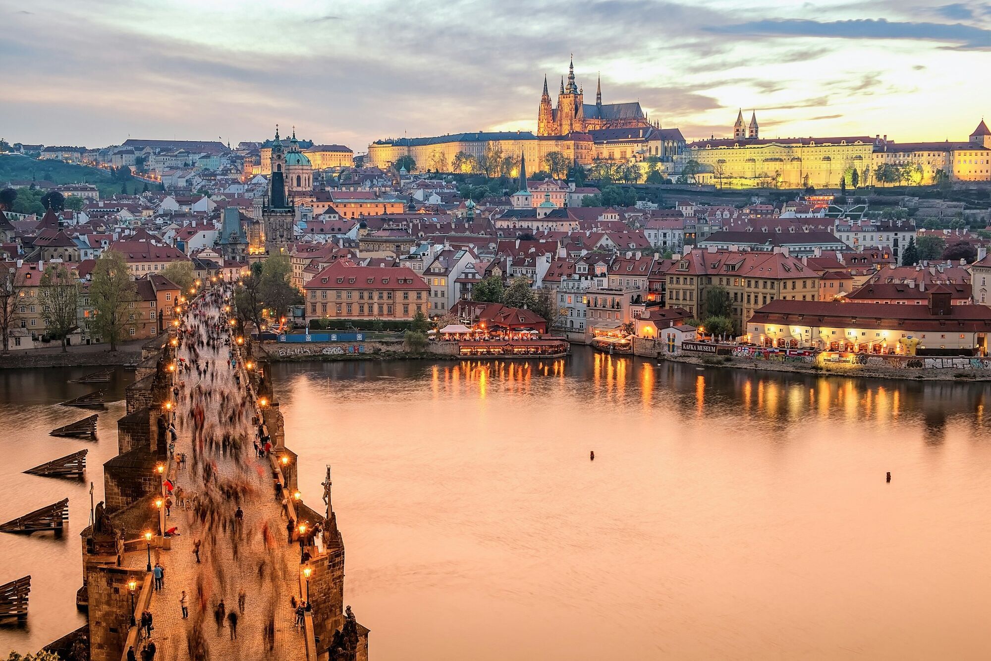 Evening view of Prague’s historic center with Charles Bridge over the Vltava River