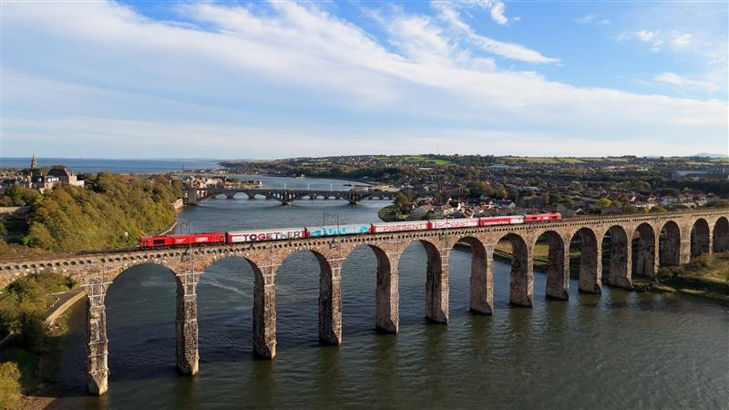 Inspiration exhibition train crossing a historic railway viaduct in the UK
