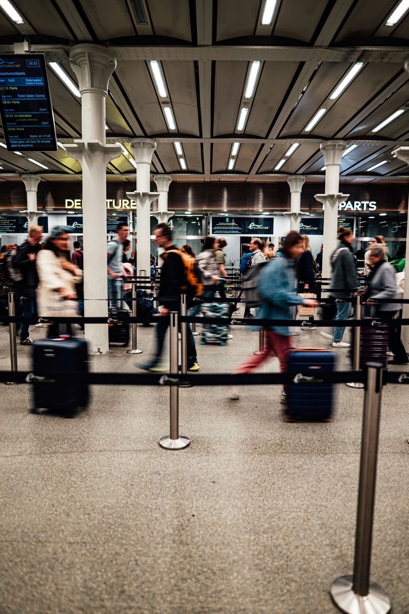 Passengers queue at a busy airport departures hall