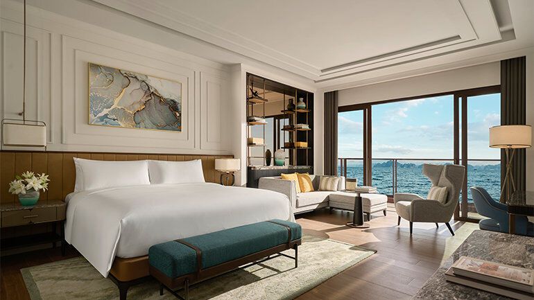 Spacious modern hotel room with large windows and ocean view