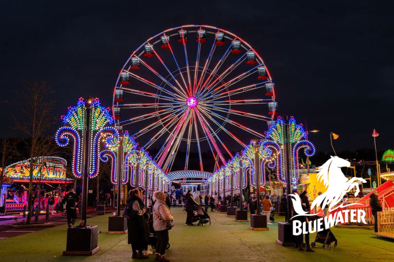 Illuminated Ferris wheel at Bluewater Winterland during night