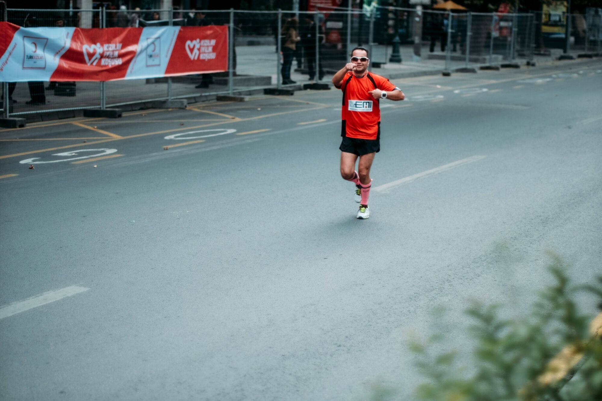 A single marathon runner on a closed road during an organised event