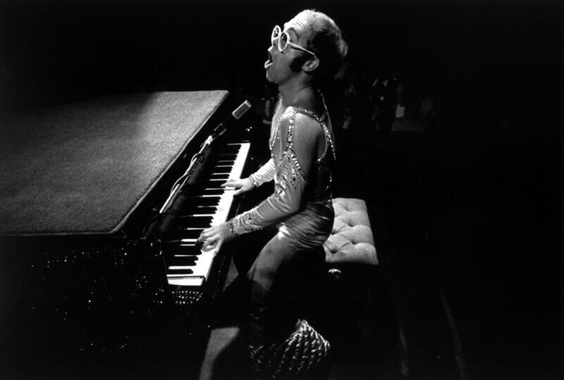 Performer in costume playing piano on stage