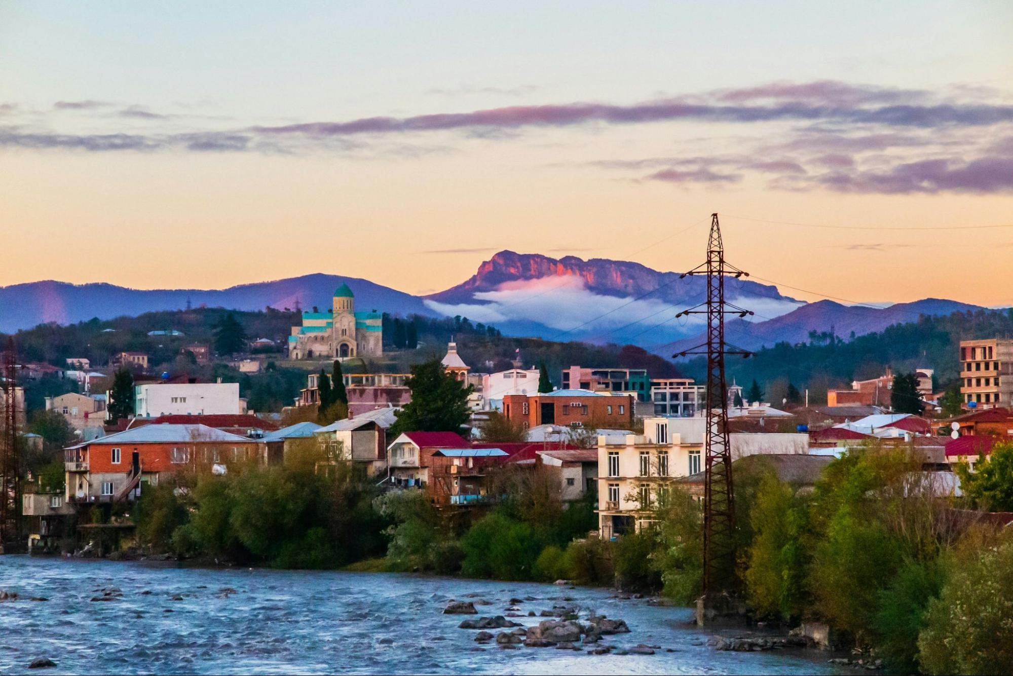 Sunset view of Kutaisi with mountains and the Bagrati Cathedral in the distance