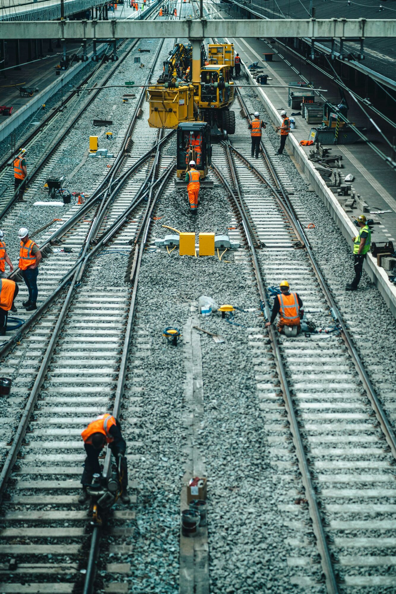 Rail workers carrying out maintenance on multiple tracks