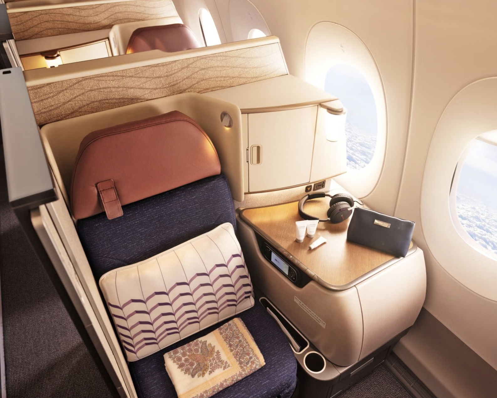 Business class seat with amenity kit and headphones