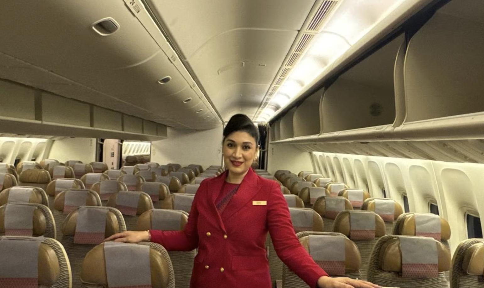 Air India cabin crew member standing in an empty aircraft cabin
