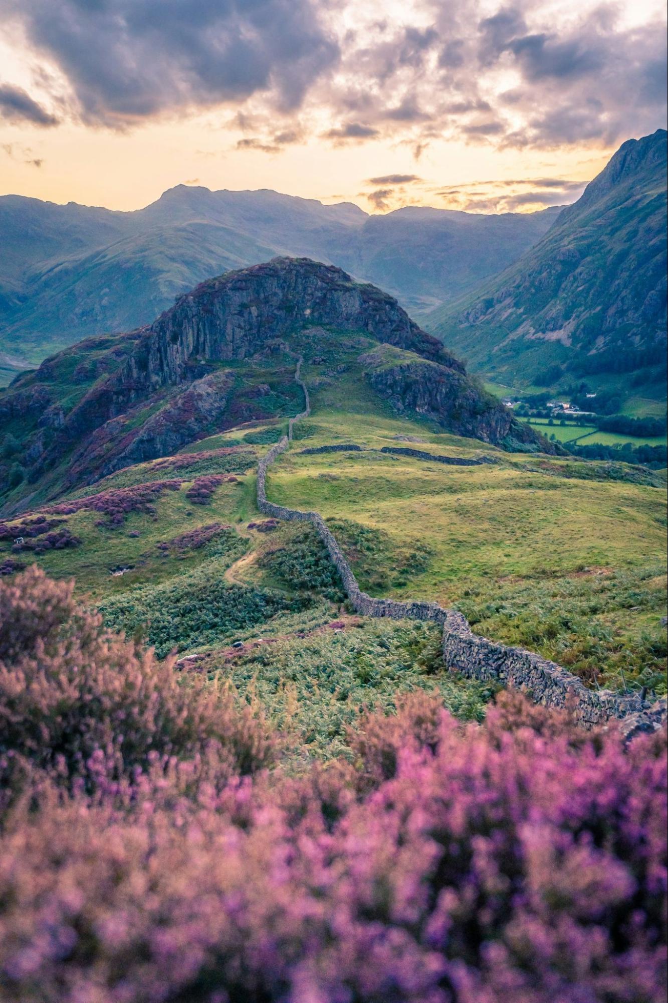 Scenic view of rolling green hills in England’s Lake District at sunset