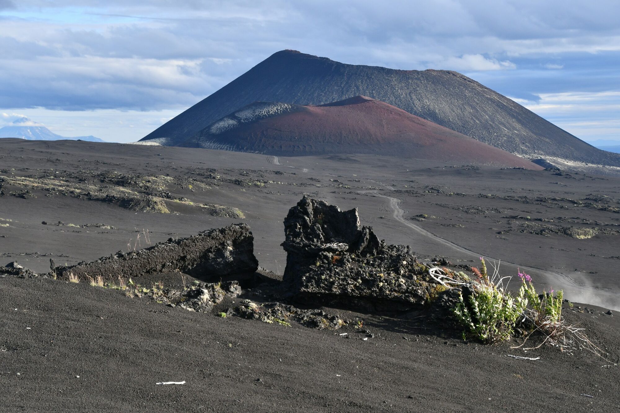 Volcanic landscape in Kamchatka with dark ash and lava fields