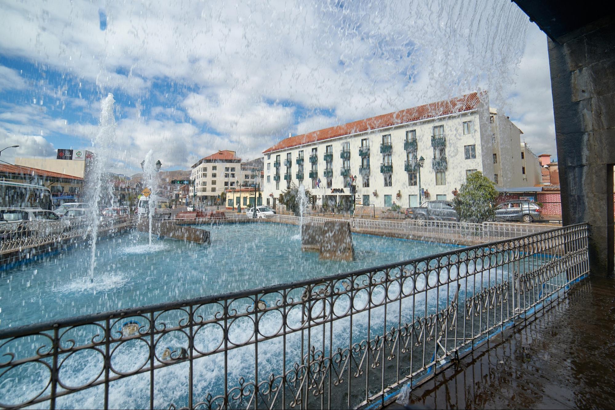 Fountain and surrounding buildings in central Cusco, Peru