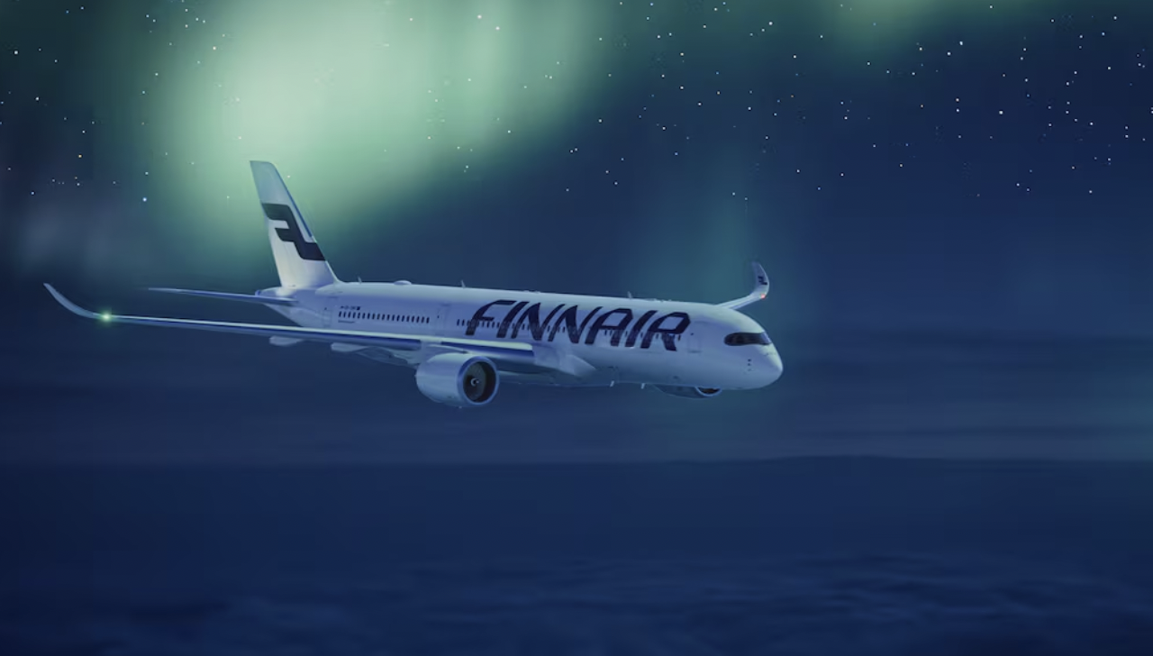Finnair aircraft flying under the northern lights