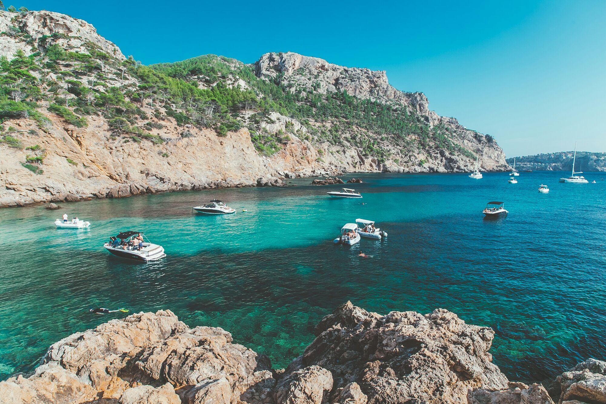 Boats anchored in a turquoise bay in Mallorca
