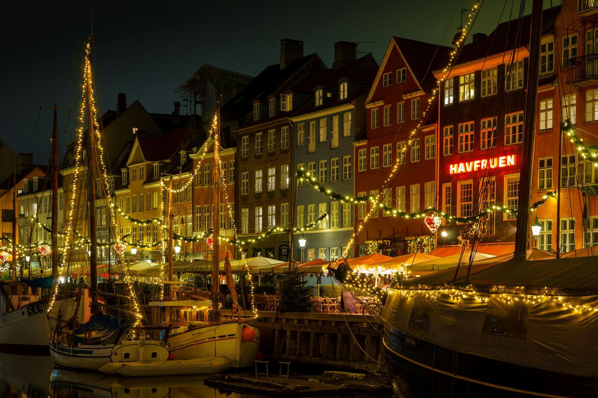 Copenhagen harbour illuminated with festive lights in winter