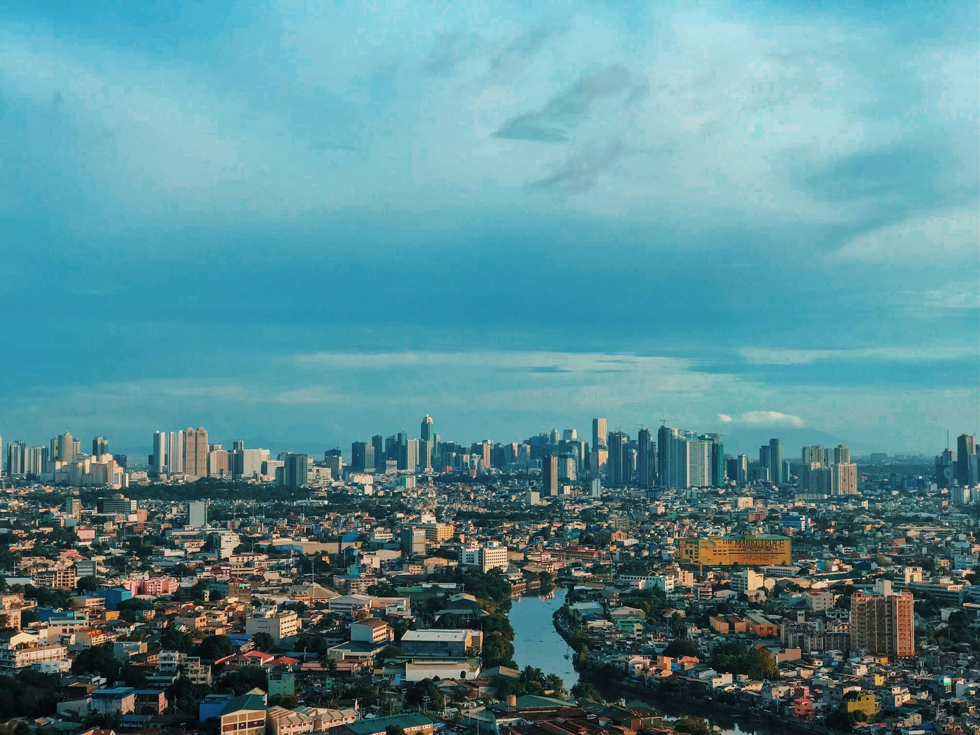 Wide view of Manila skyline with river running through the city