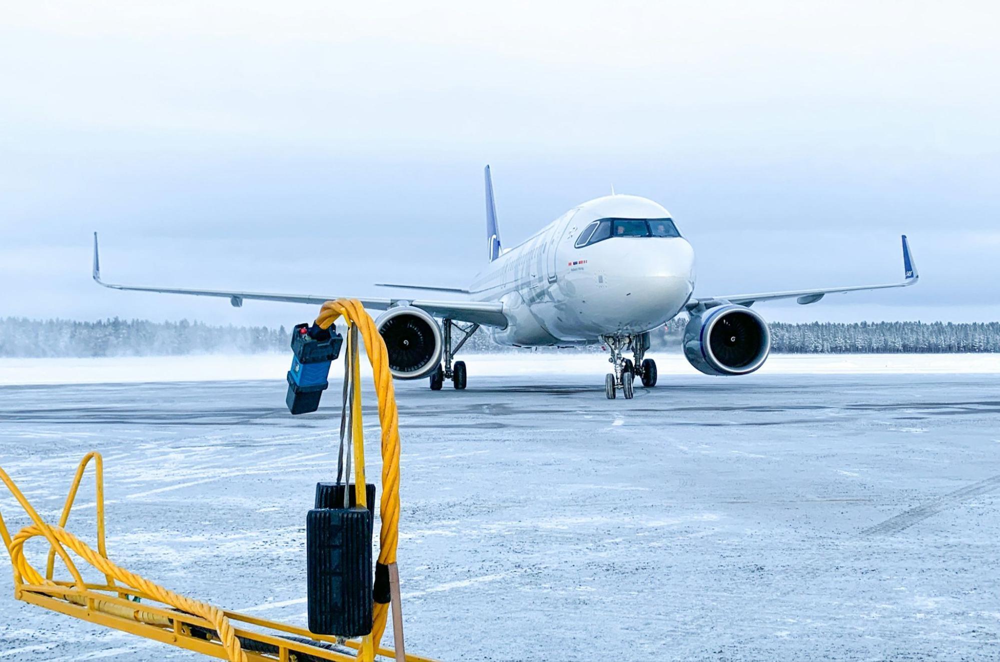 Commercial aircraft on a snow-covered runway during winter conditions