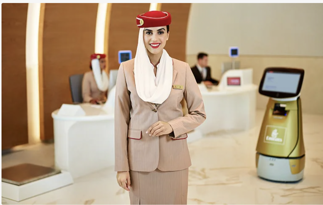 Emirates ground staff assisting passengers at airport check-in