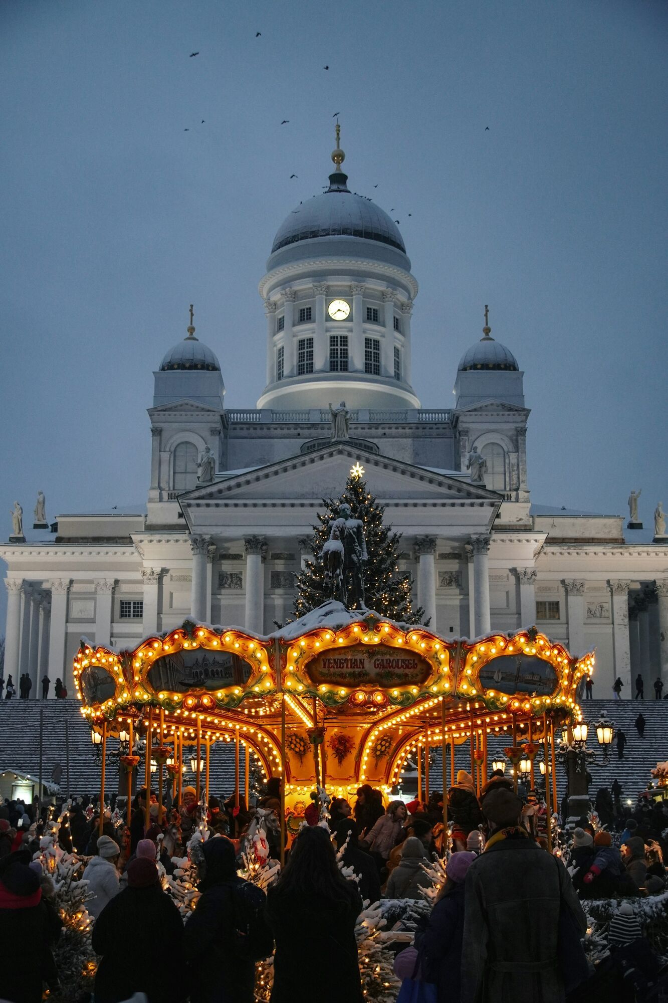 Christmas market lights glowing across Senate Square during winter