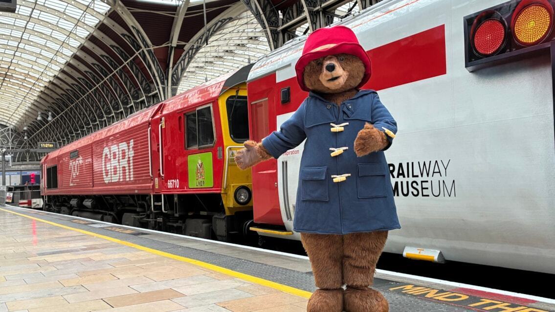 Paddington Bear greeting visitors beside the Railway 200 exhibition train at London Paddington