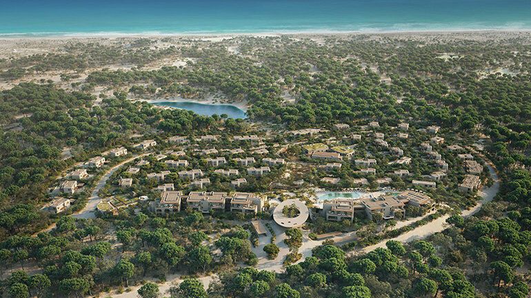 An aerial view of Six Senses Comporta resort, surrounded by lush greenery and close to the Atlantic coastline