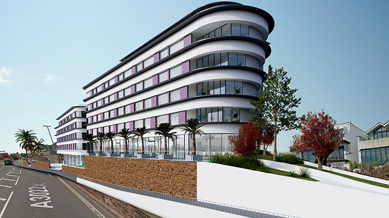 Modern curved hotel building along a sloped street in Torquay